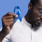 african american man holding blue ribbon 1 85x85